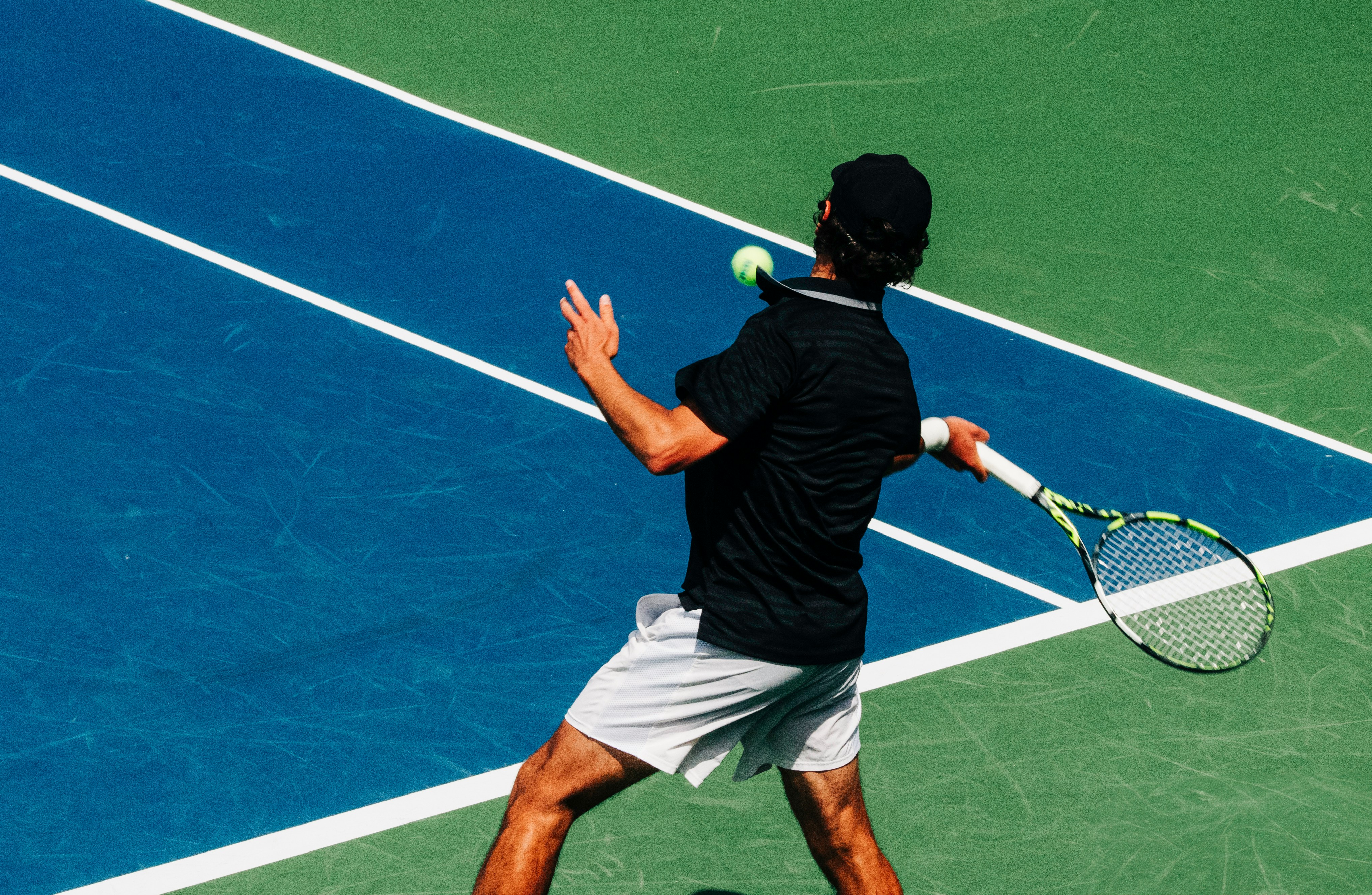 The source photo: a tennis player mid-forehand on a blue hard court